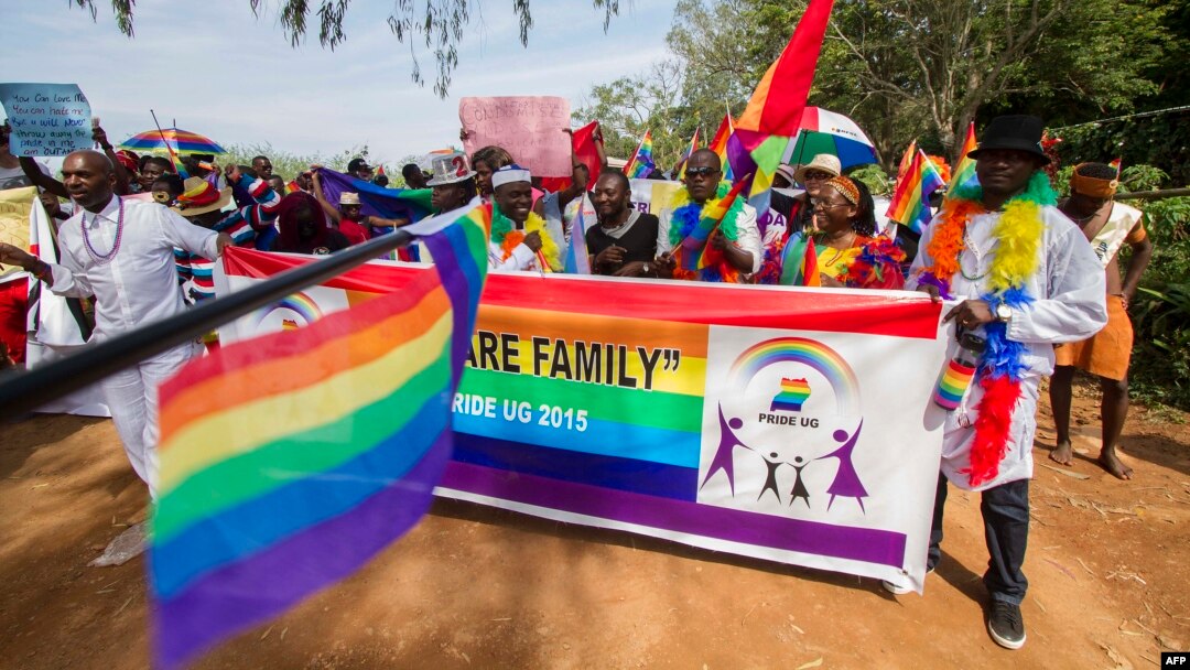 FILE - People holding rainbow flags take part in a Gay Pride parade in Entebbe, Uganda, Aug. 8, 2015. Critics of the new NGO bill say organizations such as those promoting LGBT rights will likely be among those stifled.