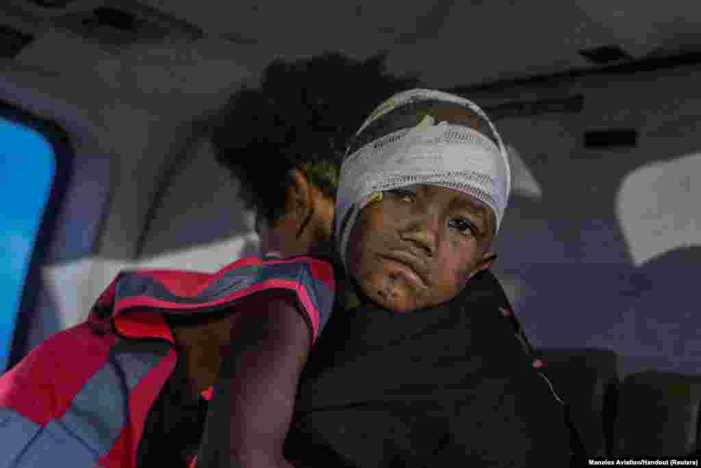 An injured child is airlifted following an earthquake in Obura-Wonenara, Papua New Guinea, Sept. 11, 2022.