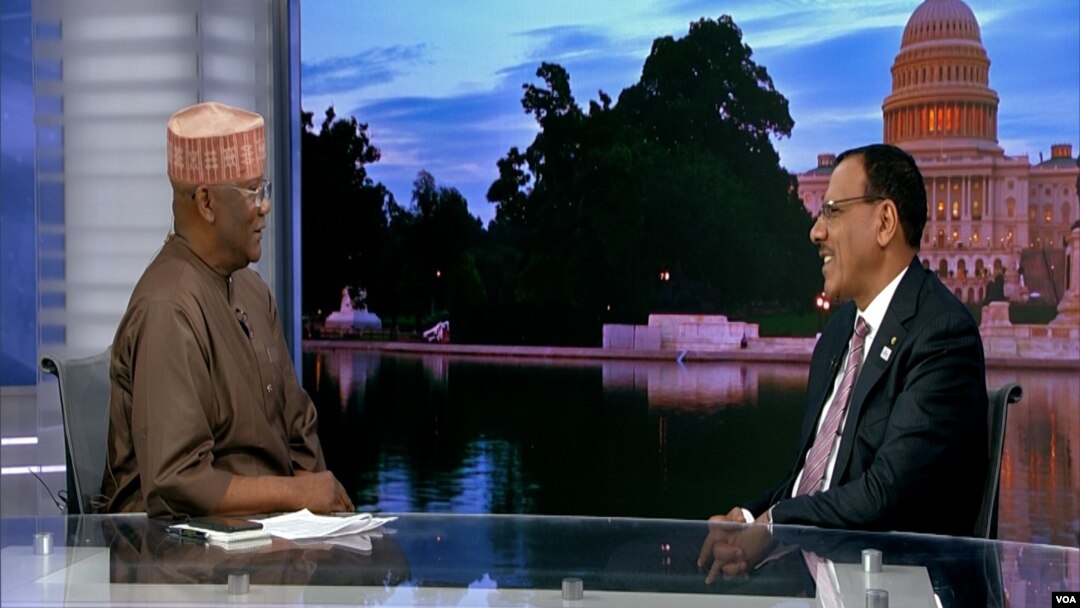 FILE - In this screengrab from video, Niger's President Mohamed Bazoum, right, sits for an interview with VOA Hausa Service chief Aliyu Mustapha at VOA headquarters in Washington, Dec. 13, 2022.