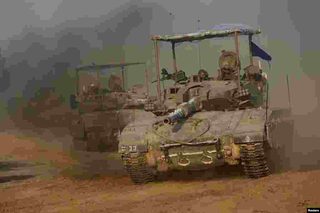 A convoy of Israeli tanks maneuvers near Israel's border with Gaza, amid the ongoing conflict between Israel and the Palestinian Islamist group Hamas, in Israel.