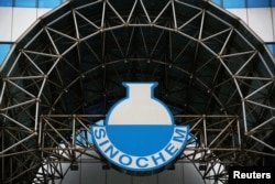 FILE - A logo of Sinochem is seen outside an office building of Sinochem in Beijing, China, Feb. 21, 2017.