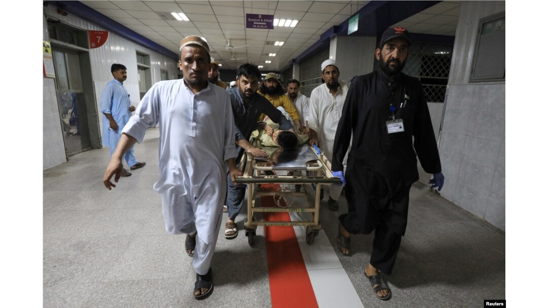 People transport a man, who was injured after a blast in Bajaur district of Khyber Pakhtunkhwa, at the Lady Reading Hospital in Peshawar, Pakistan, July 30, 2023.
