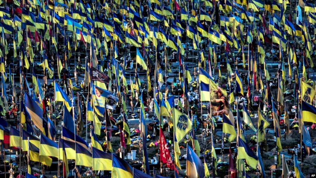 Ukrainian flags flutter over hundreds graves of Ukrainian servicemen killed in fighting since Russian invasion, in Kharkiv, Ukraine, June 6, 2024.