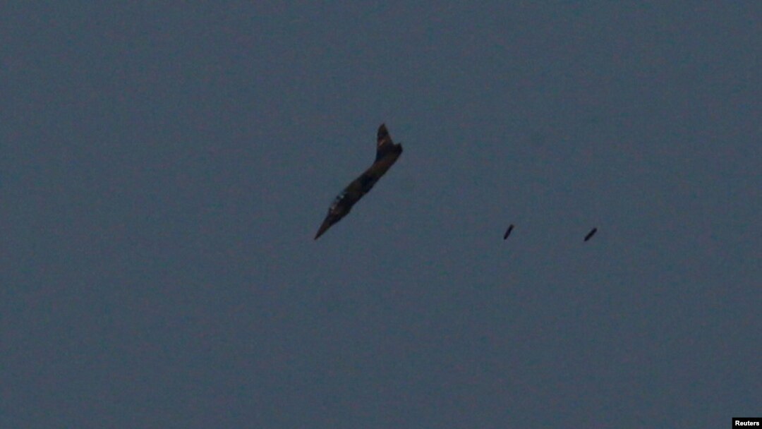 FILE - A warplane carries out a bombing run above Syria near the Israeli-Syrian border as it is seen from the Israeli-occupied Golan Heights, Israel July 24, 2018.