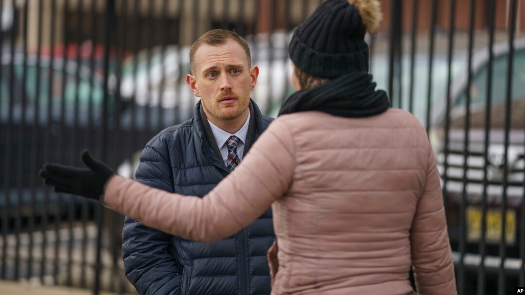 FILE - Josh Kruger, left, then communications director at Philadelphia's Office of Homeless Services at City, at a tent encampment in Philadelphia, on Jan. 6, 2020. The journalist and advocate was shot and killed at his home on Oct. 2, 2023.