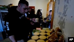 Volunteers distribute food at an abandoned hotel in the southern Lebanon town of Marwanieh, March 15, 2024. 