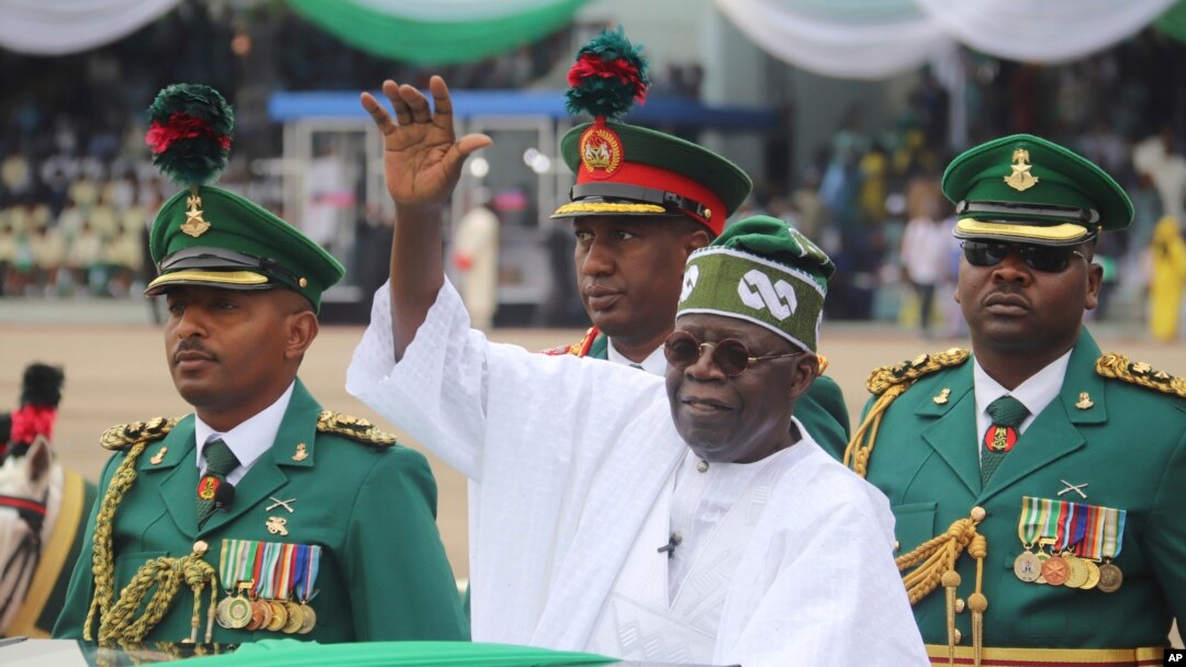 FILE - Nigeria's new President Bola Ahmed Tinubu inspects honor guards after taking an oath of office at a ceremony in Abuja, Nigeria, May 29, 2023.