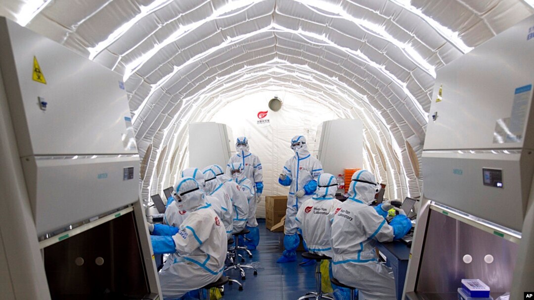 FILE - Staffers work in an inflatable COVID-19 testing lab provided by China's BGI Genomics in Beijing, June 23, 2020. China strongly objected March 3, 2023, after BGI Group and 17 others were hit with curbs on access to U.S. technology. (Xinhua via AP)