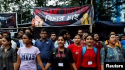 Medical students hold hands in Kolkata, India, as they protest what they say was the rape and murder of a trainee doctor in a state-run hospital in Kolkata, the capital of the state of West Bengal, Aug. 14, 2024. 