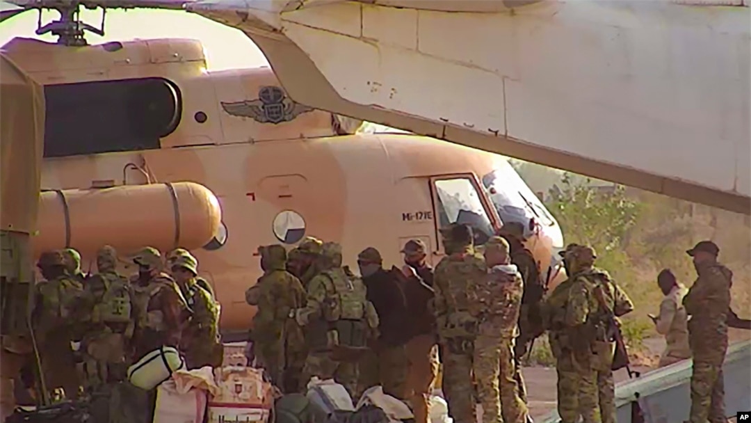 FILE - This undated photograph handed out by French military shows Russian mercenaries boarding a helicopter in northern Mali. 