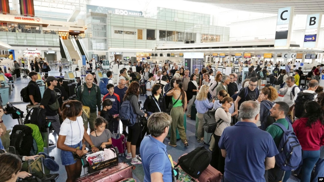 Passengers are seen at the international flight terminal at the Haneda airport, in Tokyo as a strong typhoon approaches Tokyo area, Aug. 16, 2024. 