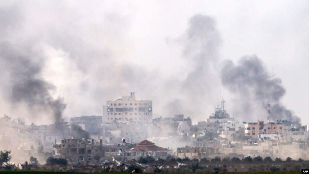 A picture taken from southern Israel near the border with the Gaza Strip on Dec. 10, 2023, shows smoke rising above buildings during Israeli bombardments on Khan Yunis. 