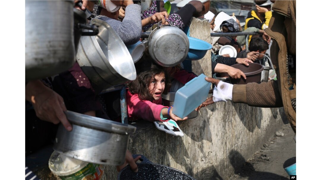 Palestinians line up for free food during the ongoing Israeli air and ground offensive on the Gaza Strip in Rafah, Jan. 9, 2024.