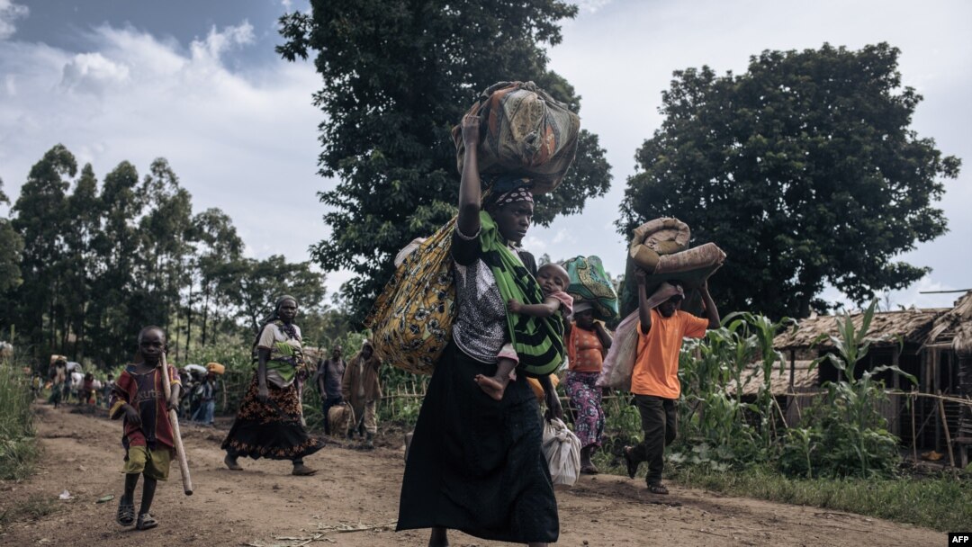 Residents of Bambo in Rutshuru territory, 60 kilometers north of Goma, the capital of North Kivu, eastern Democratic Republic of Congo, flee as the M23 attacked the town, Oct. 26, 2023. 