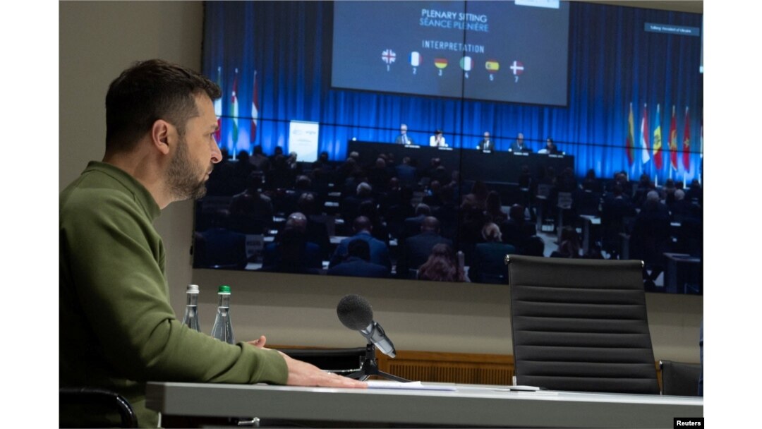 Ukrainian President Volodymyr Zelenskyy speaks via video link during the NATO Parliamentary Assembly in Copenhagen, amid Russia's attack on Ukraine, in Kyiv, Ukraine, Oct. 9, 2023. (Ukrainian Presidential Press Service/Handout via Reuters)