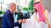In this photo released by the Saudi Press Agency, Saudi Crown Prince Mohammed bin Salman greets President Joe Biden with a fist bump after his arrival in Jeddah, Saudi Arabia, July 15, 2022.