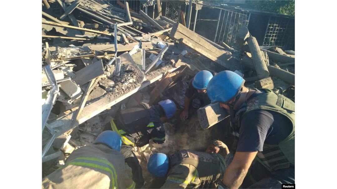 Rescuers release a man from the ruins of a residential building destroyed by a Russian military strike in the town of Toretsk, Donetsk region, Ukraine July 18, 2022, in this photo released by the State Emergency Service of Ukraine.