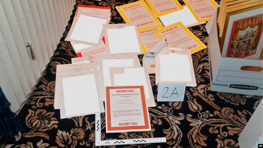 FILE - This image from a court filing by the Department of Justice on Aug. 30, 2022, and redacted by in part by the FBI, shows a photo of documents seized during the Aug. 8 search by the FBI of former President Donald Trump's Mar-a-Lago estate in Florida. 