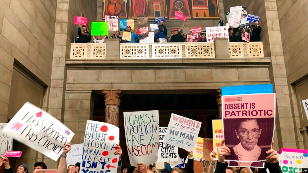 FILE - Supporters of abortion rights rally against recently passed restrictions on abortions in the Statehouse rotunda Tuesday, May 21, 2019, at the Nebraska Capitol in Lincoln, Nebraska.