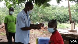 FILE - A villager in southern Malawi readies for a COVID-19 shot on Jan. 18, 2022. The country launched a new vaccination campaign on Jan. 29, 2024. (Lameck Masina/VOA)
