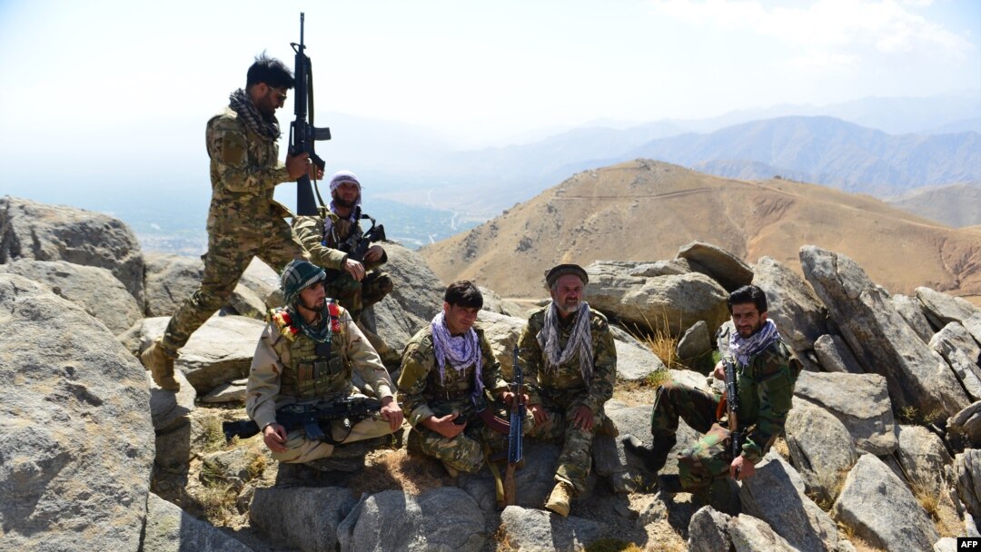 FILE - Afghan resistance movement and anti-Taliban forces take a break as they patrol on a hilltop in the Darband area of Anaba district, in Afghanistan's Panjshir province, Sept. 1, 2021.