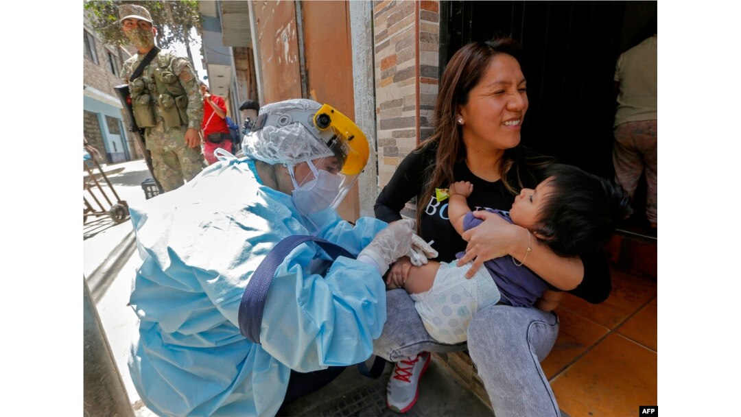 FILE - A health worker applies a vaccine against diphtheria to a baby in Lima, on Oct. 28, 2020.