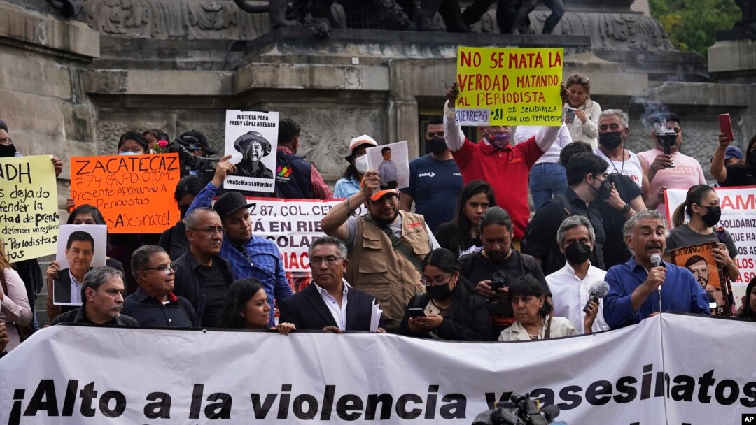 FILE - Journalists protest to draw attention to journalist killings,at the Angel of Independence monument in Mexico City, May 9, 2022. Mexico remains one of the most dangerous countries for journalists. 