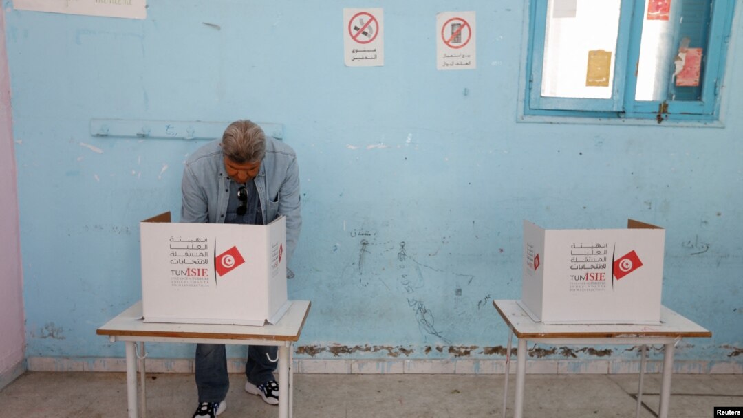 A man votes at a polling station during parliamentary election in Tunis, Tunisia Dec. 17, 2022. 