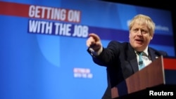 British Prime Minister Boris Johnson gestures while speaking during the Conservative Party Spring Conference in Blackpool, Britain, March 19, 2022. 