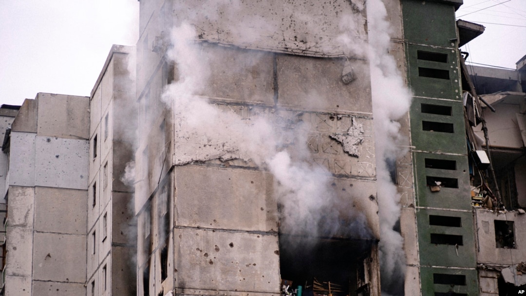 FILE: Smoke rises out of an apartment building damaged by shelling in Chernihiv, Ukraine, March 3, 2022. 