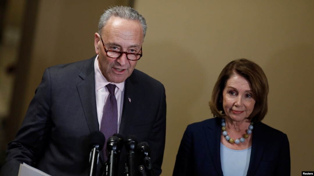 FILE - Senate Minority Leader Chuck Schumer and House Minority Leader Nancy Pelosi speak at a news conference.