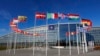 FILE - A NATO flag and flags of member contries flutter in the wind outside NATO headquarters in Brussels, Feb. 7, 2022. 