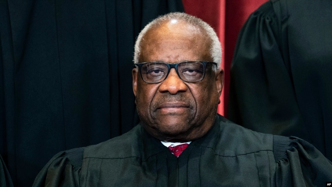 FILE - Justice Clarence Thomas sits during a group photo at the Supreme Court in Washington, April 23, 2021. 