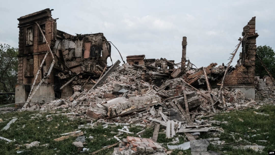 FILE - The remains of a destroyed school are pictured following a Russian military strike on the village of Bilohorivka, Luhansk region, eastern Ukraine, on May 13, 2022. Ukrainian officials say 60 people sheltering in the building's basement died in the attack.