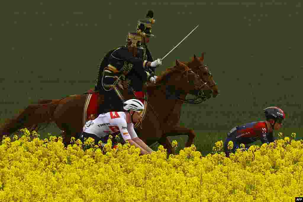 Hungarian hussars ride along competitors during the first stage of the Giro d'Italia 2022 cycling race, 195 kilometers between Budapest and Visegrad, Hungary.