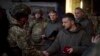Ukrainian President Volodymyr Zelenskyy awards a serviceman in Bakhmut, Ukraine, Dec. 20, 2022. (Ukrainian Presidential Press Office)
