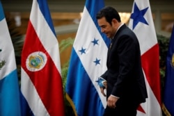 FILE - Guatemala's President Jimmy Morales is seen before a family photo during a meeting of the Central American Integration System in Guatemala City.