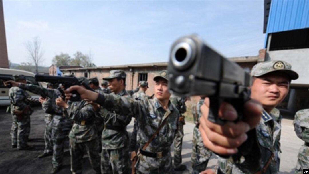 Chinese soldiers practice with their pistols at an undisclosed training camp in central China's Henan province (File)