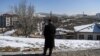 FILE - A man stands on the heights of the city to look at the view, in Erzurum, east Turkey, March 5, 2021. 