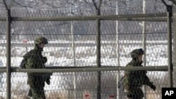 South Korean border guards patrol the fence-line at the Imjingak Pavilion near the border village of Panmunjom in Paju, 01 Jan 2011