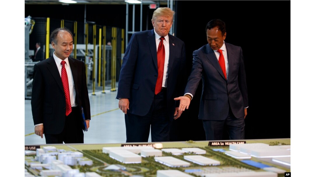 President Donald Trump takes a tour of Foxconn with Foxconn chairman Terry Gou, right, and CEO of SoftBank, Masayoshi Son, June 28, 2018, in Mt. Pleasant, Wisconsin.