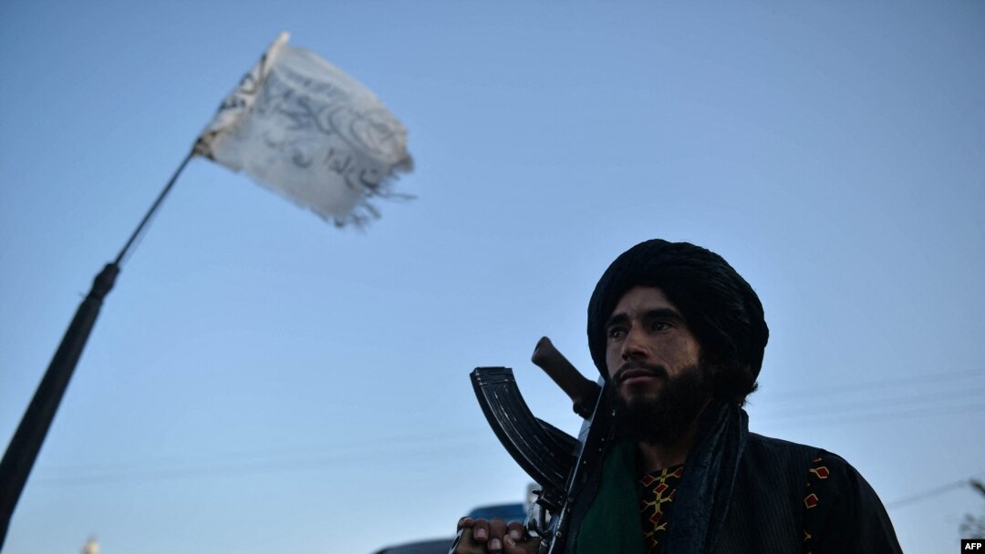 A Taliban fighter stands along a road in Herat on Sept. 19, 2021.