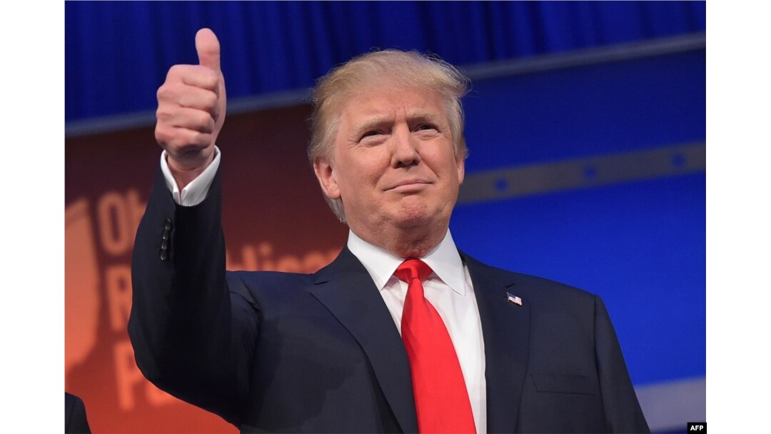 Real estate tycoon Donald Trump flashes the thumbs-up as he arrives on stage for the start of the prime time Republican presidential debate on Aug. 6, 2015 at the Quicken Loans Arena in Cleveland, Ohio.