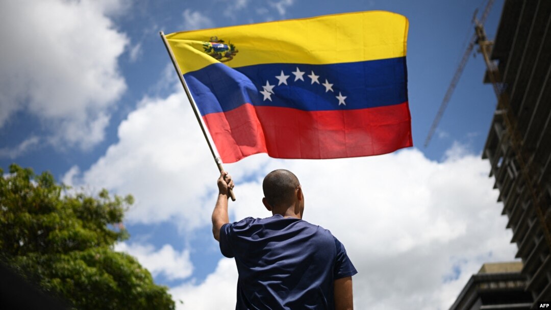 FILE - A man waves a Venezuelan flag in Caracas on Aug. 17, 2024. 