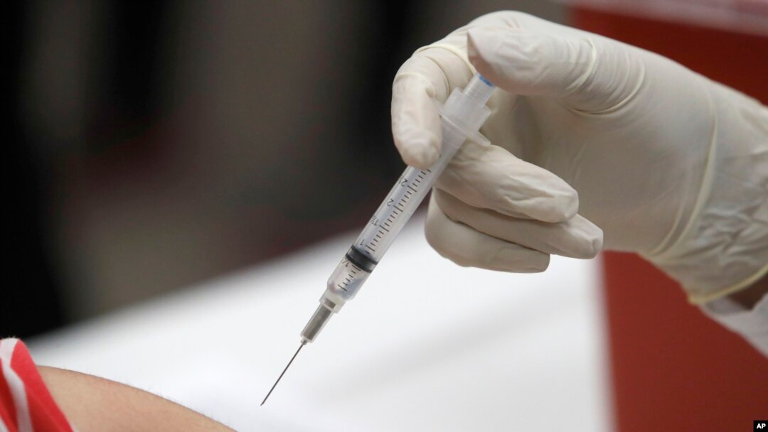 FILE - This Jan. 23, 2020 file photo shows a patient receiving a flu vaccination in Mesquite, Texas.