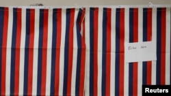 A voter fills out a ballot inside a voting booth for New Hampshire's first-in-the-nation U.S. presidential primary election at the Stark volunteer fire dept. in Stark, New Hampshire, Feb. 11, 2020.