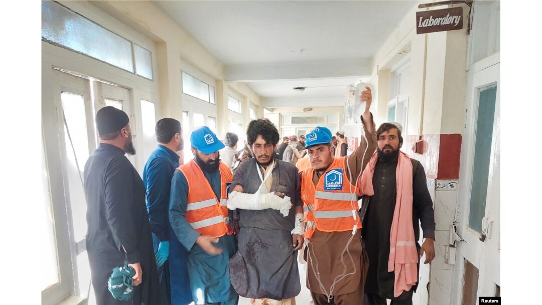 Rescue workers escort a man injured during cross-border shelling and gunfire, at a hospital in the Pakistan-Afghanistan border town of Chaman, Pakistan, Dec. 15, 2022.