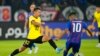 FILE - Huang Kaizho of Guangzhou Evergrande, left, fights for the ball against Leandro Velazquez of Johor Darul Ta'zim during a soccer match at Sultan Ibrahim Stadium in Johor, Malaysia, on April 15, 2022.