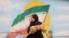 A woman walks down in a street in Tehran, Iran, Dec. 6, 2022, as rumors swirl about the status of the country's morality police. (Majid Asgaripour/WANA via Reuters)
