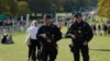 British police officers patrol along the Long Walk towards Cambridge gate outside Windsor Castle in Windsor, England, Sept. 18, 2022. 